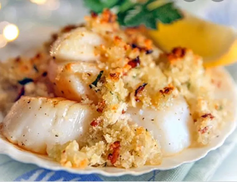 Baked stuffed scallops with a crumb topping and lemon